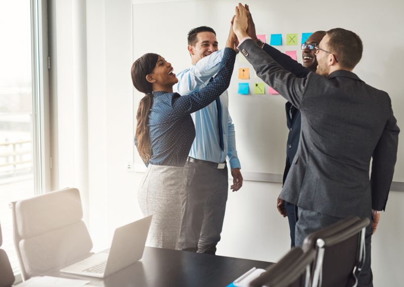 Business team celebrating success with a group high-five